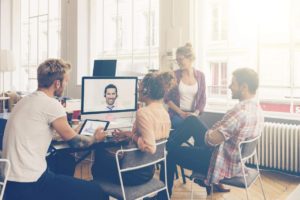 Coworkers doing a video conference in the conference room