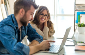 Employees looking at computer screen