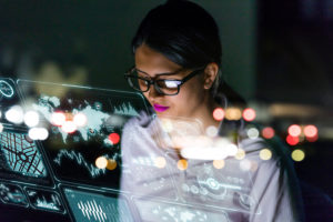 businesswoman looking at futuristic interface screen.